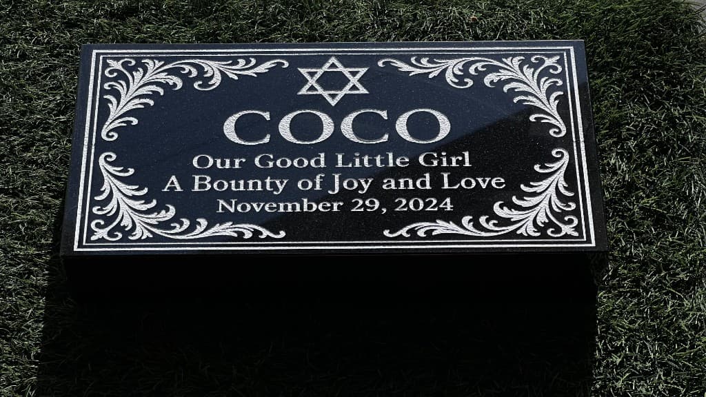 Custom laser-etched granite pet memorial — the kind of finished piece our personalization flows are built to support.
