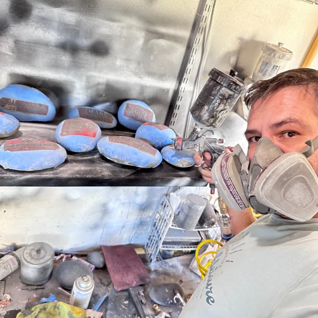 Workshop scene: careful finishing of custom memorial stones — showing the hands-on craftsmanship behind our products.